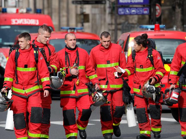 Firefighters walk near Paris police headquarters in the heart of central Paris. Picture: AFP