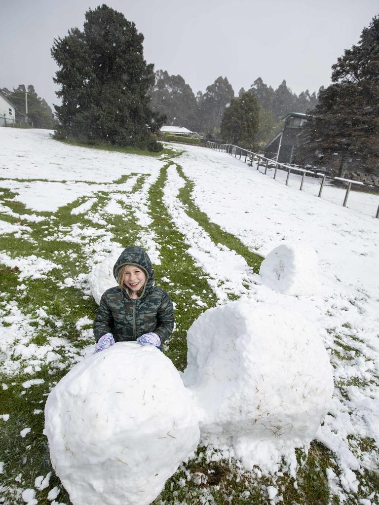 Lizzy (8) celebrating the latest Spring snow at home at Fern Tree. Picture Eddie Safarik