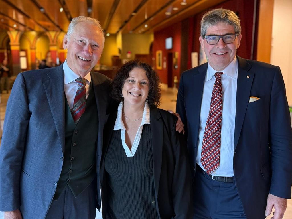 Kathleen folbigg at Parliament House with two vocal supporters Mark Rudder, left and Peter Yates.