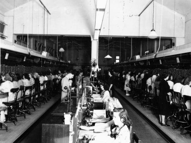 Telephone switchboard operators connect calls in the central exchange room, circa 1948, in the General Post Office building on King William St.