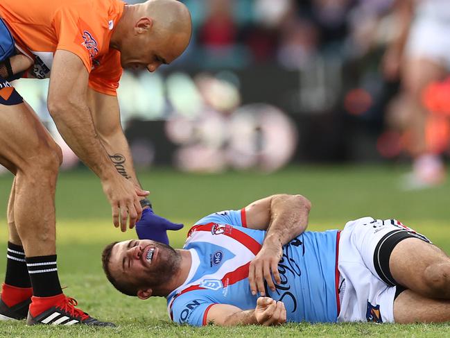 SYDNEY, AUSTRALIA - APRIL 25: James Tedesco of the Roosters lays is attended to by a trainer after a tackle made by Jordan Pereira of the Dragons during the round seven NRL match between the Sydney Roosters and the St George Illawarra Dragons at the Sydney Cricket Ground, on April 25, 2021, in Sydney, Australia. (Photo by Cameron Spencer/Getty Images)