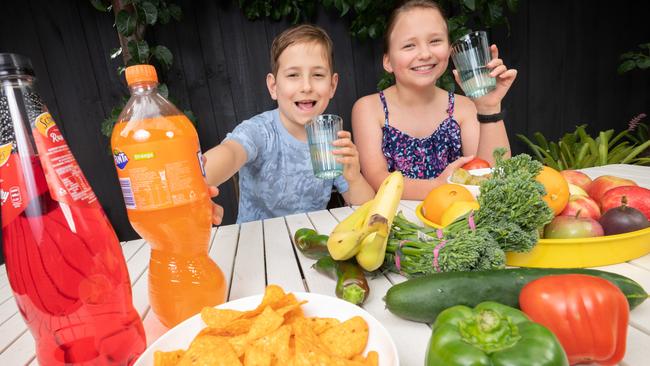 Twins Alice and Tom Perillo-Phipps, 9, with healthy and unhealthy snacks. Picture: Tony Gough