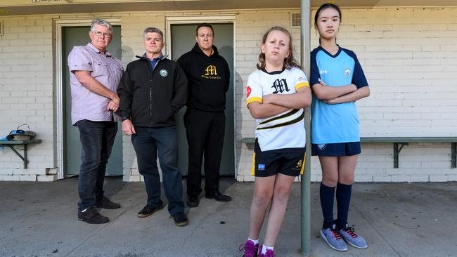 Cr Jim McGee, Glen Eira FC general manager Stewart Howell and Mackie Cricket Club junior co-ordinator Ryan Fishlock with Hannah, 8, and Kayden, 12. Picture: Penny Stephens