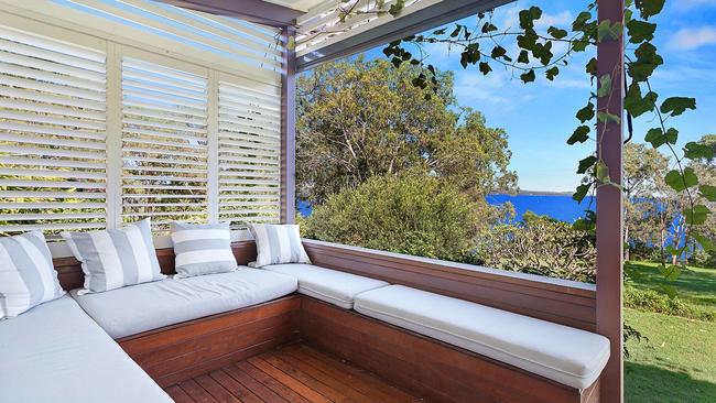 Read a book by the bush with water views. Photo: Stayz
