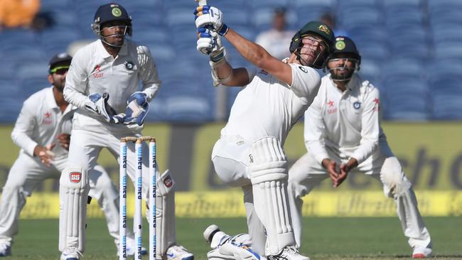 Australia's Mitchell Starc made 63 in Pune in 2017. Picture: AFP / Indranil Mukherjee