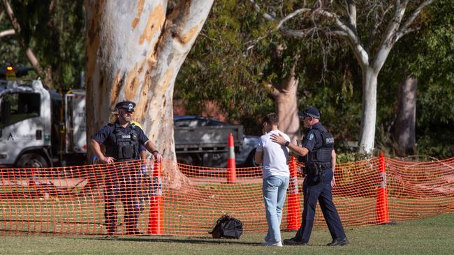 The friend is comforted by police. Picture: Brett Hartwig