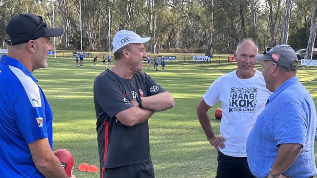 John Longmire catches up with old clubmates and lifelong friends as he takes training last year. Picture: Shannon Gill