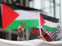 COLOGNE, GERMANY - MAY 15: A demonstrator shows the victory sign as he waves a Palestinian flag while marching to commemorate the 76th anniversary of the Nakba on May 15, 2024 in Cologne, Germany. The Nakba is what Palestinians refer to as the "catastrophe", when approximately 750,000 Palestinians were forced to flee their homeland by Jewish paramilitaries during the 1948 Palestine War that led to the creation of Israel. In Germany commemorating the Nakba is a hyper-sensitive issue, with local tabloids having branded participants as "Jew haters" following past marches. This year's march is taking place as the Israeli invasion of Gaza continues, with over a million Palestinians displaced and thousands of homes destroyed by Israeli bombing following the Hamas massacres of Israelis last year. (Photo by Pau Barrena/Getty Images)