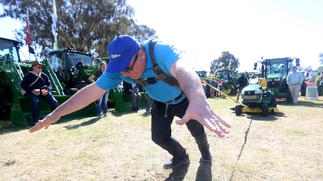 Community members enjoyiong the ride on mower pull at the John Deere site at the Henty Machinery Field Days. Picture: Yuri Kouzmin