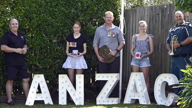 Preparing for Anzac Day with a difference in the front yard of their North Toowoomba home. From left; Wayne Hamlet – Impact Lighting Co, Olivia Clark, Anthony Clark, Olivia Clark and Jarrod Rowden. Photo Bev Lacey