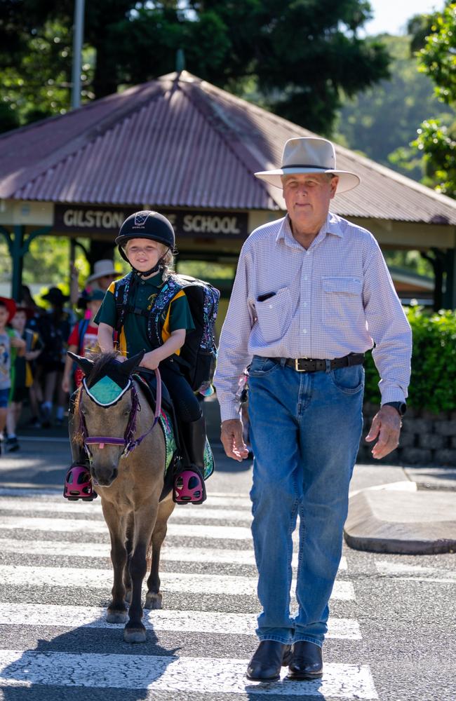 Billie Collins arrives at Gilston State School with her horse Winnie as part of the school's Active School Travel day, accompanied by her grandfather Steven Andrews. Picture: Matthew Andrews.