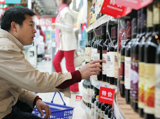 Cui Yongdong buys a bottle of wine in Beijing, China November 22, 2005. Doug Kanter/Bloomberg News