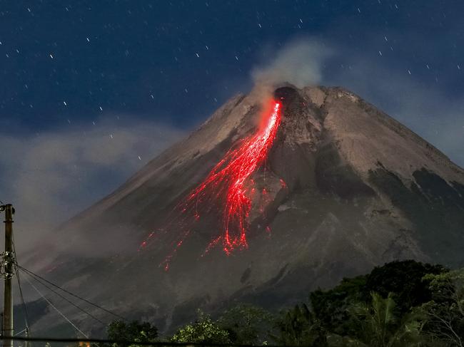 A long exposure image of Mount Merapi spewing lava onto its slopes during an eruption as seen from Sleman in Indoneisa. Picture: Devi Rahman/AFP