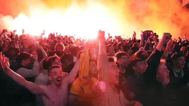 Fans celebrate Australia‘s win in the World Cup game between Australia and Denmark in Federation Square, Melbourne. Picture: NCA NewsWire / David Crosling