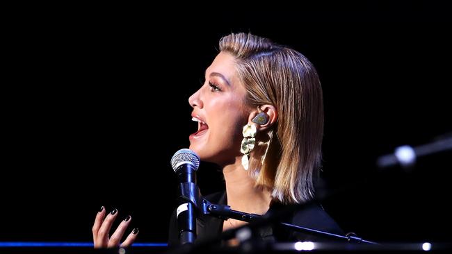 SYDNEY, AUSTRALIA - FEBRUARY 23: Delta Goodrem performs 'Let It Rain' during a State Memorial Service honouring people killed in the NSW Bushfires at Qudos Bank Arena on February 23, 2020 in Sydney, Australia. The memorial honours those who died in recent bushfires, and all those people and communities impacted by the fires.  25 people were killed in New South Wales this bushfire season, while thousands of homes and buildings were destroyed. Around 4.9 million hectares was also burned in the state during the nationwide fire crisis. (Photo by Cameron Spencer/Getty Images)