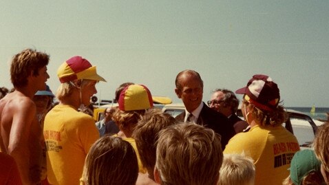 His Royal Highness Prince Philip, Duke of Edinburgh with Surf Lifesavers on Surfers Paradise Beach, Gold Coast, Queensland, October 1982. Picture: Pauline Holley (Image courtesy of the City of Gold Coast Local Studies Library).