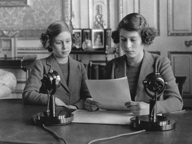 Princesses Elizabeth and Margaret making a broadcast to the children of the Empire during World War II. Picture: Topical Press Agency/Getty Images