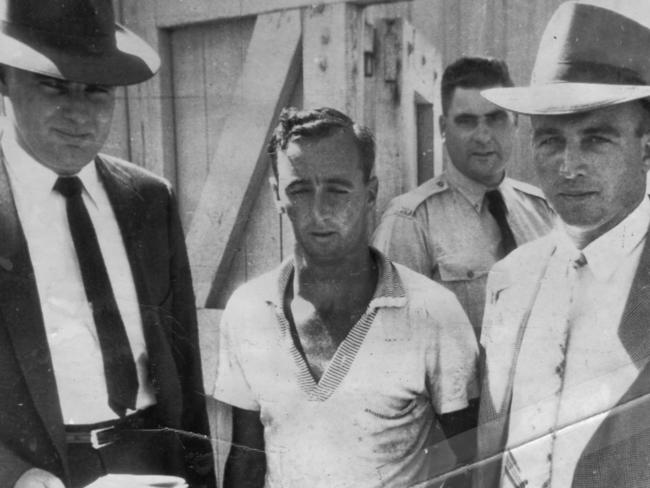 Glen Patrick Hallahan, left, and a Mount Isa officer escort Raymond Bailey, centre, after his arrest. File picture