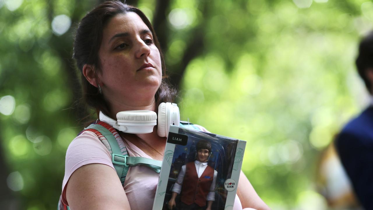 A fan holds a toy figurine of One Direction singer Liam Payne. Picture: Marcos Brindicci/Getty Images