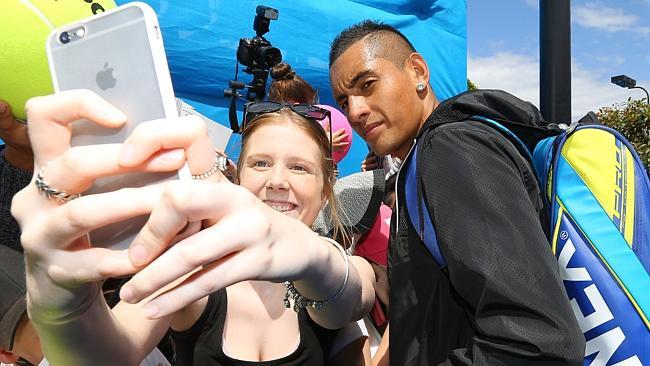 Nick Kyrgios poses for a photo with a fan on his way to practice on Australia Day, the day after his epic, come-from-behind win against Andreas Seppi.