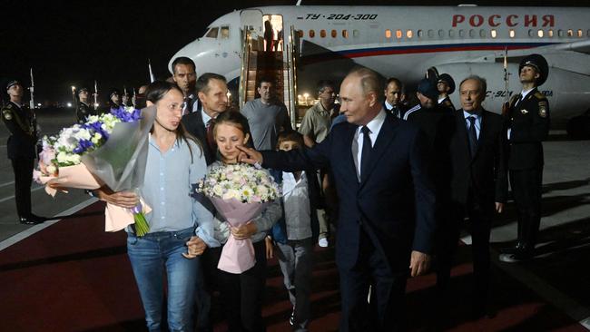 Anna and Artem Dultsev arrive in Moscow alongside their children, Daniel and Sophie. Picture: AFP