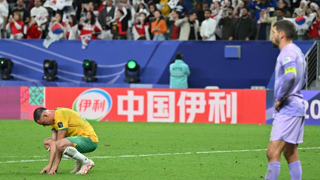 Lewis Miller (left) is shattered after the Socceroos’ Asian Cup quarter-final loss to South Korea. Pictured: Hector Retamal / AFP