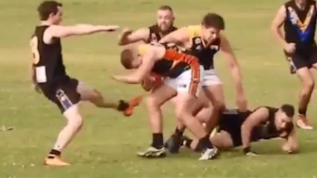 Salisbury West player Adam Jones, left, was reported four times in the same Adelaide Footy League match against Trinity Old Scholars, including once for kicking.