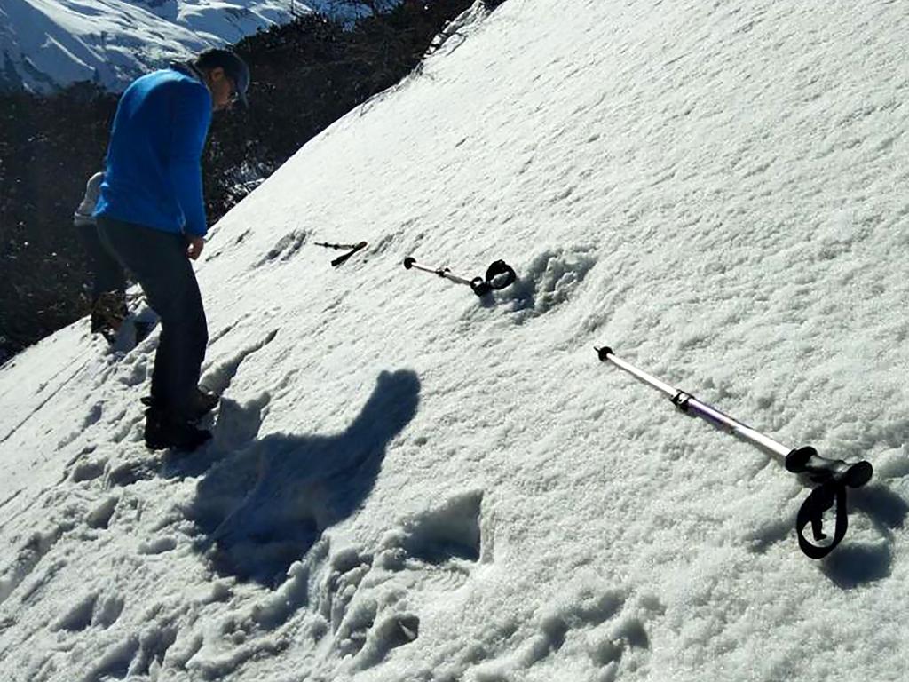 In this handout photo taken by the Indian Army on April 9, the large footprints in the snow  are measured. Picture: AFP