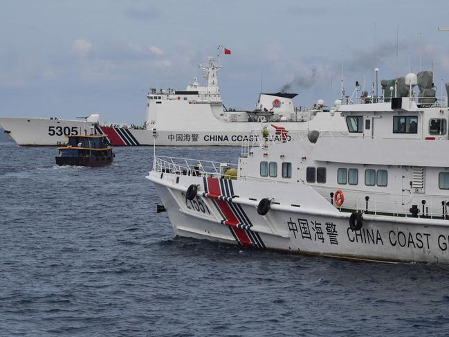 Chinese coast guard ships corralling a Philippine civilian boat chartered by the Philippine navy to deliver supplies in their own Exclusive Economic Zone waters in the disputed South China Sea.