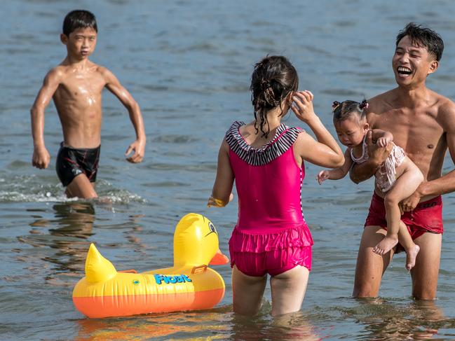 A family frolics in the sea at Wonsan, North Korea. Picture: Getty