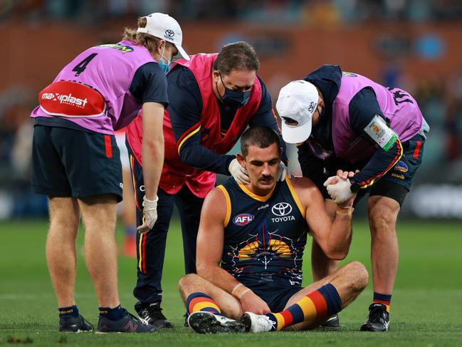 Taylor Walker is attended to by club trainers after hurting his neck. (Picture: Daniel Kalisz/Getty Images