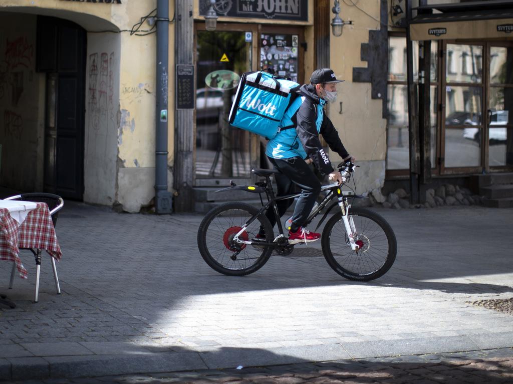 A food delivery rider wearing a face mask to prevent the spread of coronavirus. Picture: Mindaugas Kulbis/AP