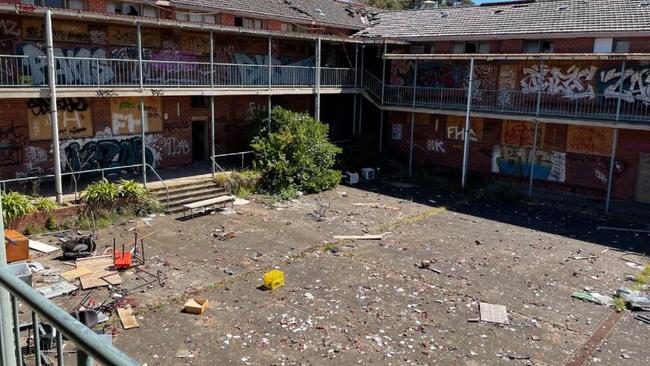 Rubbish and broken glass strewn across the courtyard of Hays International College's abandoned former boarding house in Box Hill South. Picture: Kiel Egging