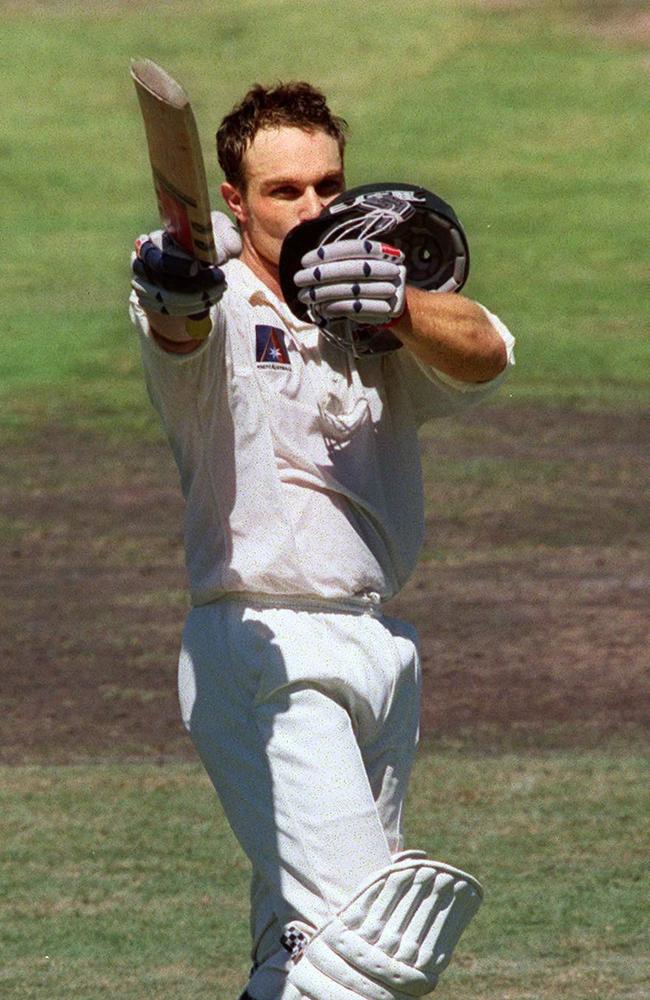 Slater kissing his helmet while celebrating his century against England at the Sydney Cricket Ground in 1999.