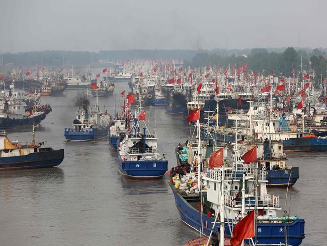 Fishing boats of China’s fishing fleet — which is organised along militia lines — head out to sea from the port in Lianyungang, in China's eastern Jiangsu province. Picture: AFP