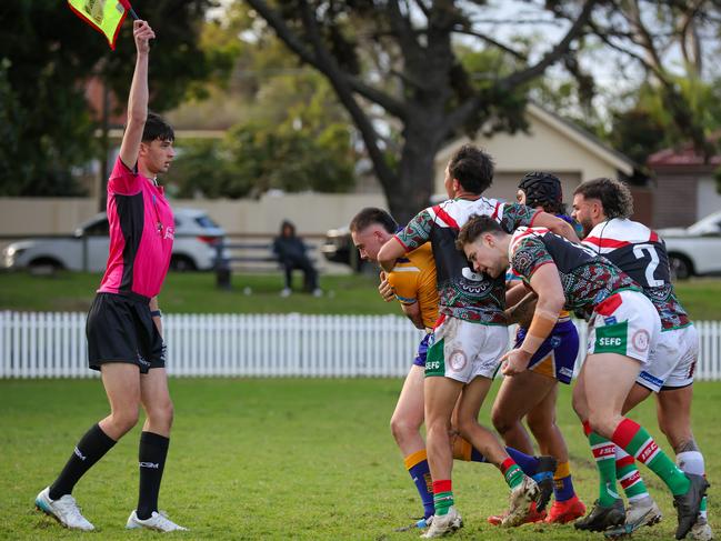 The South Eastern defence bundles Dolphins fullback Harrison Marsh over the touch line. Picture: Adam Wrightson Photography