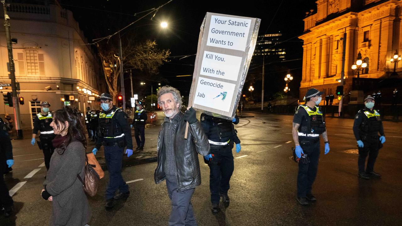 Police donned masks and gloves while many protesters ignored mask directives. Picture: Tony Gough