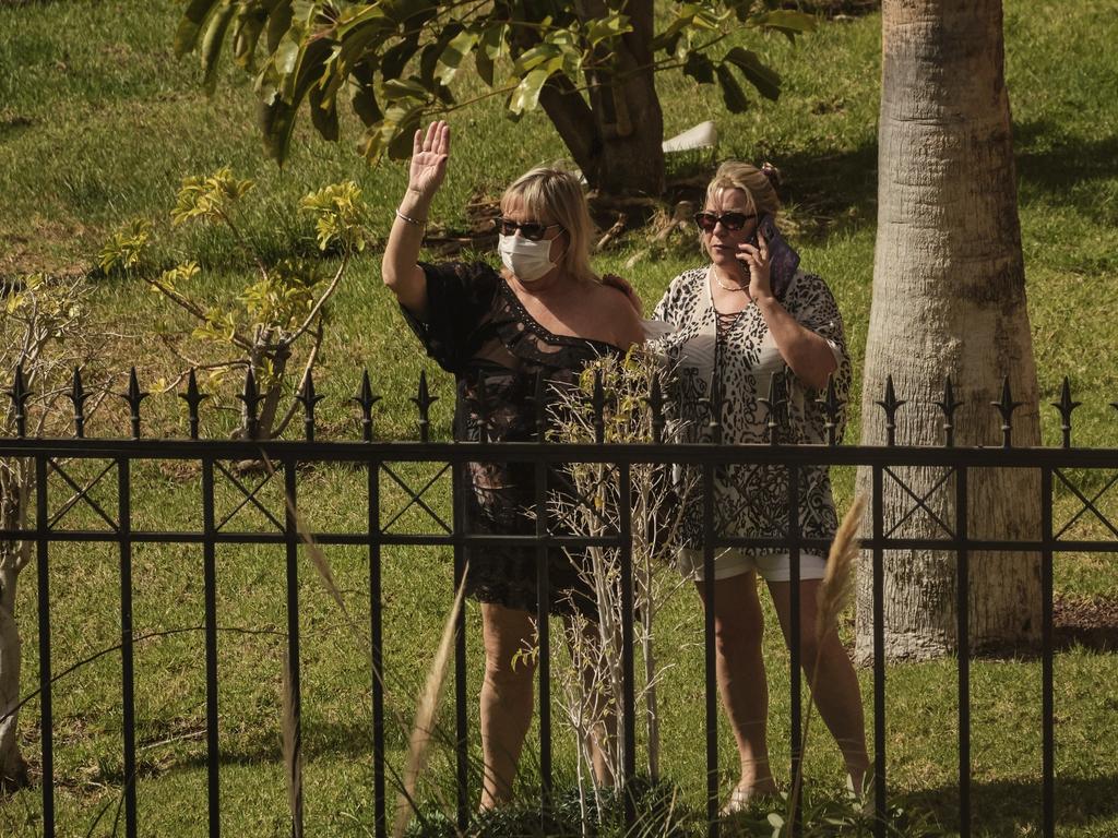 Tourists in quarantine wave from inside the resort. Picture: AP