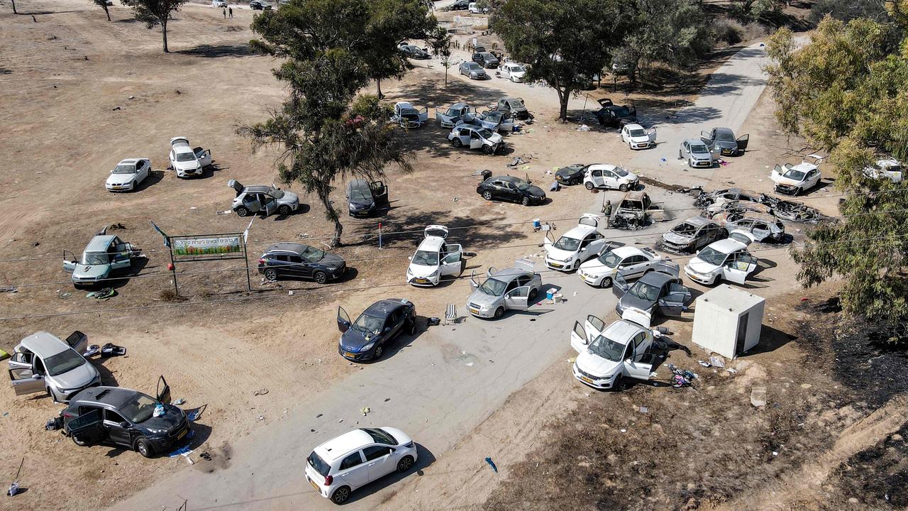 Abandoned and torched vehicles at the site of the attack on the Supernova music festival. Picture: AFP