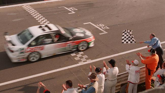 Larry Perkins takes the chequered flag at Bathurst in 1995.