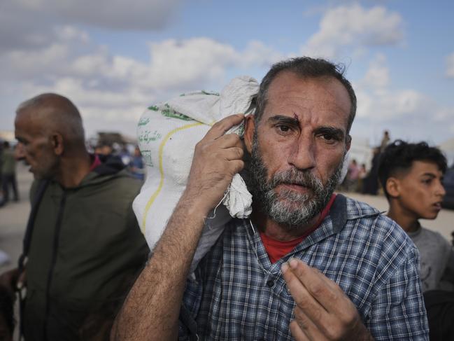 Palestinians carry bags filled with food and humanitarian aid provided by the Gaza Humanitarian Foundation, a US-backed organisation approved by Israel, in Khan Younis, southern Gaza Strip. Picture: AP Photo