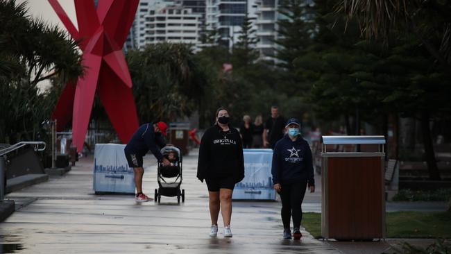 Surfers Paradise wakes up to its first day in lockdown due to the latest CoVid-19 scare. Tradesman still at work at Paradise Centre.Some consider walking a strenuous excercise and dont wear masks... Picture Glenn Hampson