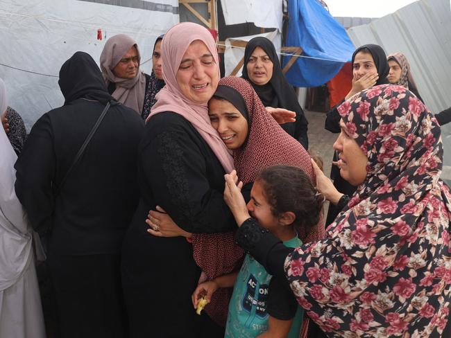 Palestinians mourn by the bodies of relatives killed in the attack. Picture: Eyad Baba/AFP