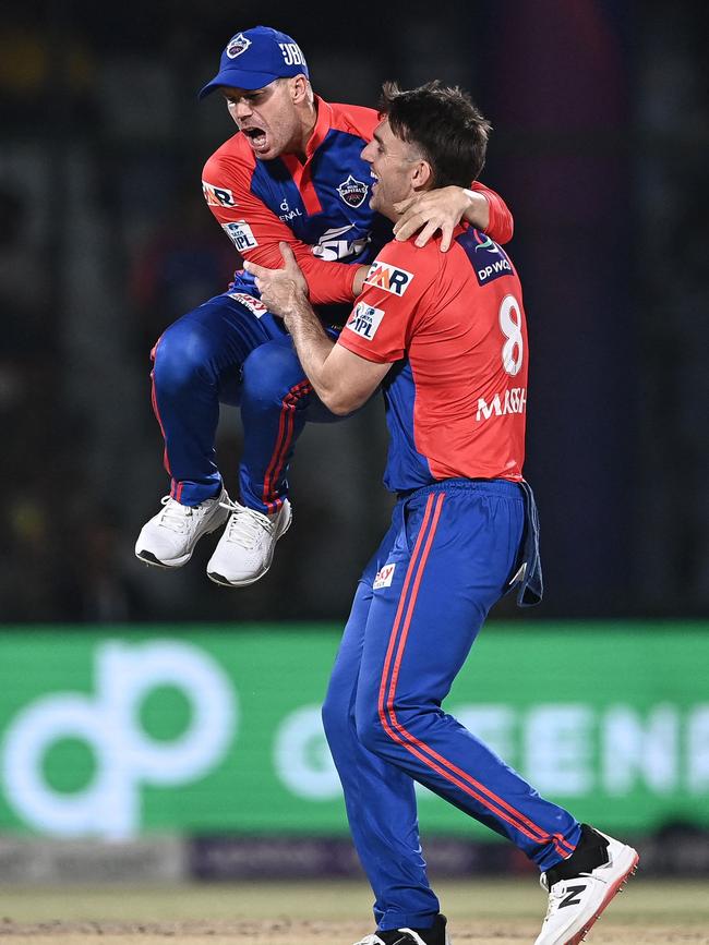 David Warner and Mitchell Marsh celebrate a wicket for the Delhi Capitals. Picture: Arun SANKAR / AFP