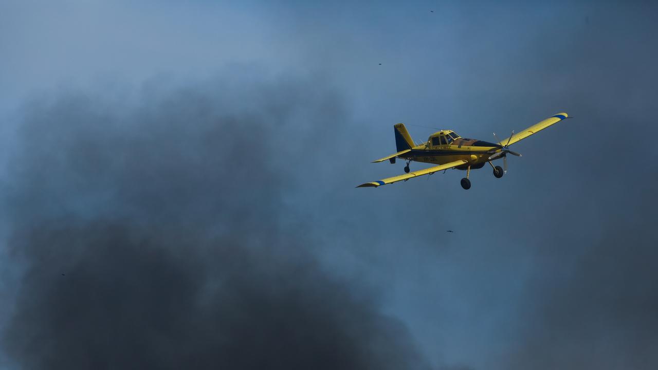 Water bombers battle dangerous fire conditions as a bushfire rolls through the Litchfield/Batchelor area in late August. Picture: Glenn Campbell