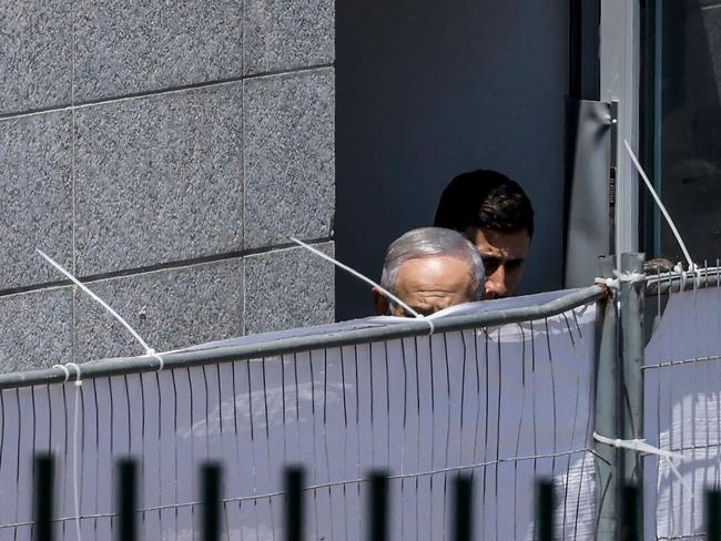 Israel's Prime Minister Benjamin Netanyahu walks behind a screen during a visit to the site of a deadly rocket attack in the Druze village of Majdal Shams. Picture: AFP