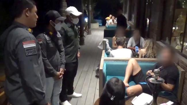 The Naughty Tourists officers question visitors to Bali. Picture: Supplied