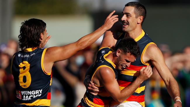 Taylor Walker celebrates his 500th AFL goal with Lachlan Murphy and Josh Rachele. Picture: Dylan Burns/AFL Photos