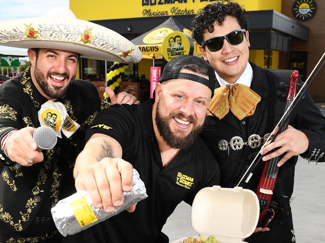 North Queensland operations manager Justin Angus (middle) with Sergio and Salvador of GYG Mariachi Band, at the opening of the new Guzman and Gomez restaurant at Fairfield Central. Picture: Shae Beplate.