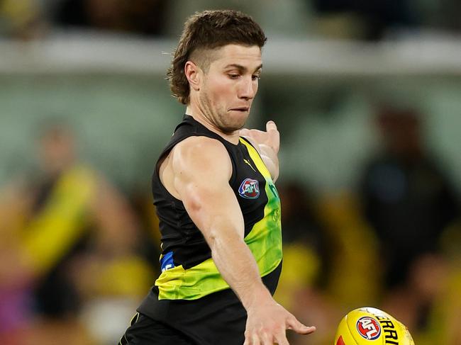 MELBOURNE, AUSTRALIA - JUNE 09: Liam Baker of the Tigers kicks the ball during the 2022 AFL Round 13 match between the Richmond Tigers and the Port Adelaide Power at the Melbourne Cricket Ground on June 09, 2022 in Melbourne, Australia. (Photo by Michael Willson/AFL Photos via Getty Images)